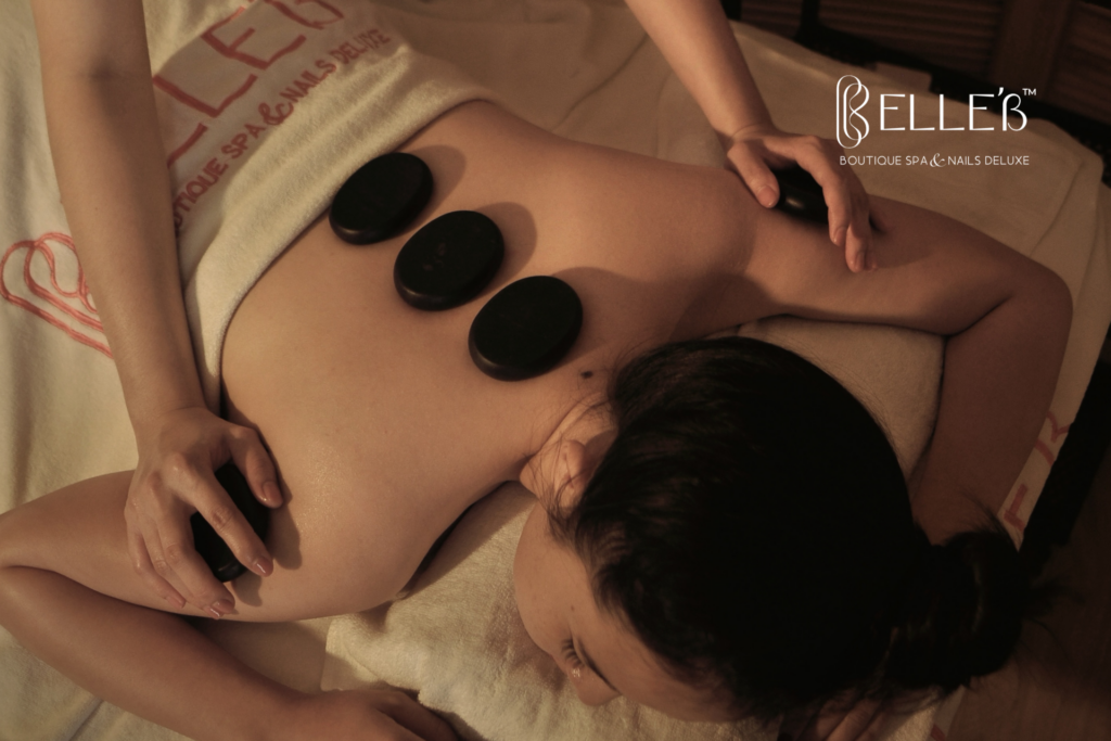 Massage therapy with hot stones at Cele'B Spa for deep relaxation and stress relief